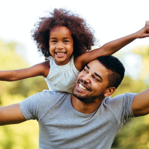 Chidl and father smiling after children's dentistry visit