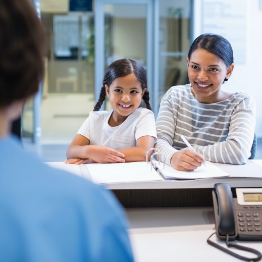 Mother and daughter discussing the cost of treating dental emergencies
