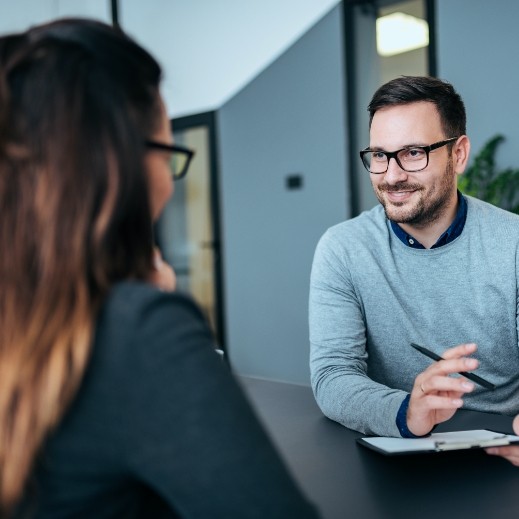 Patient discussing the cost of dental implants with dentist