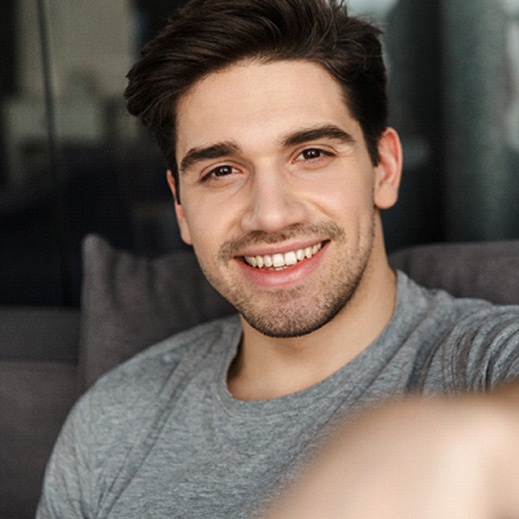 man smiling after getting smile makeover in Garland